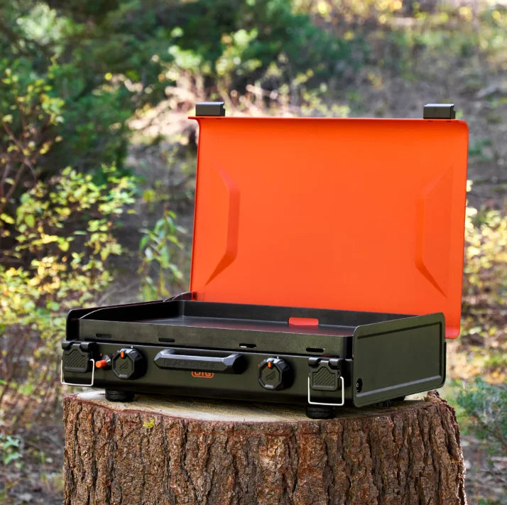 Blackstone OTG 20" Camping Griddle: Compact camping griddle featuring ceramic titanium-coated griddle plate, dual independently controlled heat zones, leveling feet, and plunger piezo ignition for easy outdoor cooking on uneven terrain.