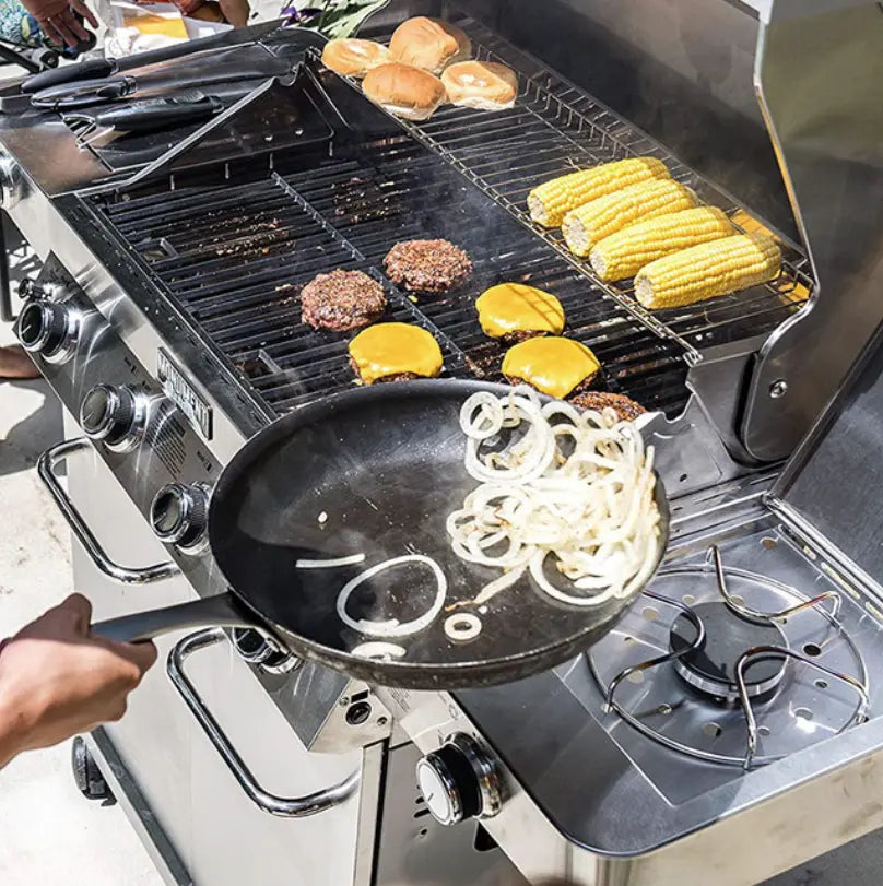 Monument Grills "24367" Classic Series 4-Burner Propane Gas Grill in polished stainless steel design with four main burners, side burner, and dedicated sear zone for versatile cooking options.