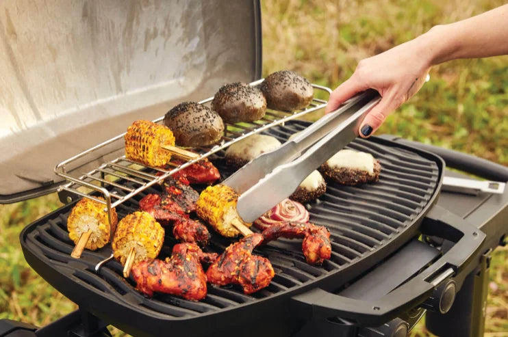 Napoleon Phantom TravelQ PRO 285 portable gas grill features sleek matte black finish, high-top lid, stainless steel burners, removable warming rack, and scissor cart for effortless transport.