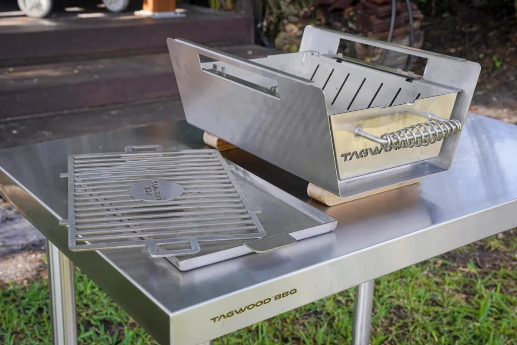 Table Top Warming Brazier made from premium 304 stainless steel with acacia wood accents, features a spacious 121 sq. in. warming surface and includes two skewers for versatile use.