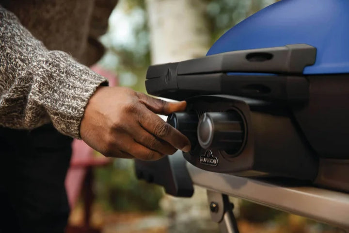 Napoleon TravelQ™ 285X Portable Propane Gas Grill - Blue/Red: Compact, powerful grill for tailgating, camping, or backyard cooking, featuring dual stainless steel burners, high-top cast aluminum lid, reversible cast iron griddle, and WAVE porcelain-coated cast iron cooking grids.