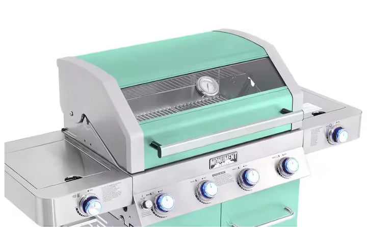 Monument Grills Green 4-Burner Gas Grill - Classic Series: A stylish and powerful stainless steel propane grill with vibrant green finish, four burners, infrared side sear burner, extra side burner, ClearView glass lid, LED backlit control knobs, and durable corrosion-resistant construction.