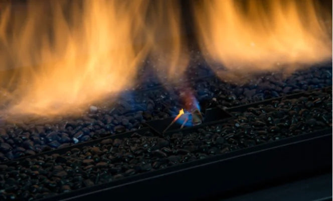 Sierra Flame Palisade 36' See-through Direct Vent Linear Fireplace: sleek curved front face design, black porcelain panels, black reflective glass, and 3 piece rock set, offering a 15” H x 32-1/2” W glass viewing area in a compact 10 7/8" deep unit.