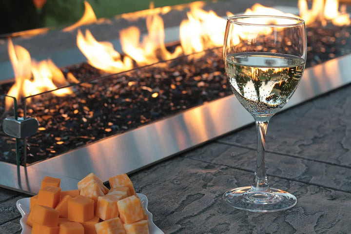 The Carol Rose Collection 48" LED Linear Outdoor Firepit features premium stainless steel construction, manual electronic ignition, and certified safe operation for propane or natural gas use, creating a cozy ambiance with adjustable LED lighting in seven colors and two modes.