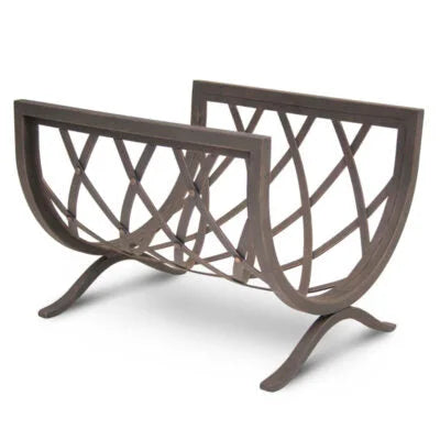 Iron Weave Log Holder by Pilgrim features a hand-forged iron frame in distressed bronze finish, showcasing intricate weave design for a sculptural touch to fireplaces and wood stoves.