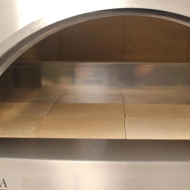 Forno Venetzia's flagship 'Torino 500' copper oven features a 32" × 24" cooking surface, accommodating up to four pizzas, with handcrafted Italian engineering and stainless steel cart for durability and convenience.