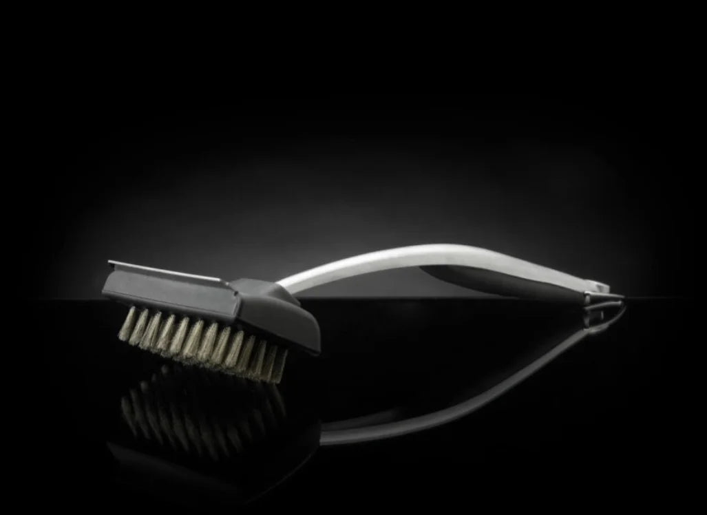 Napoleon PRO Series Stainless Steel Grill Brush: stainless steel bristles and durable body for long-lasting performance, ergonomic rubberized handle, built-in metal scraper, 18-inch length keeps hands safe from heat.