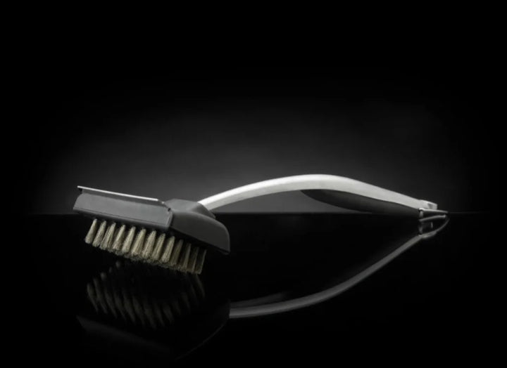 Napoleon PRO Series Stainless Steel Grill Brush: stainless steel bristles and durable body for long-lasting performance, ergonomic rubberized handle, built-in metal scraper, 18-inch length keeps hands safe from heat.