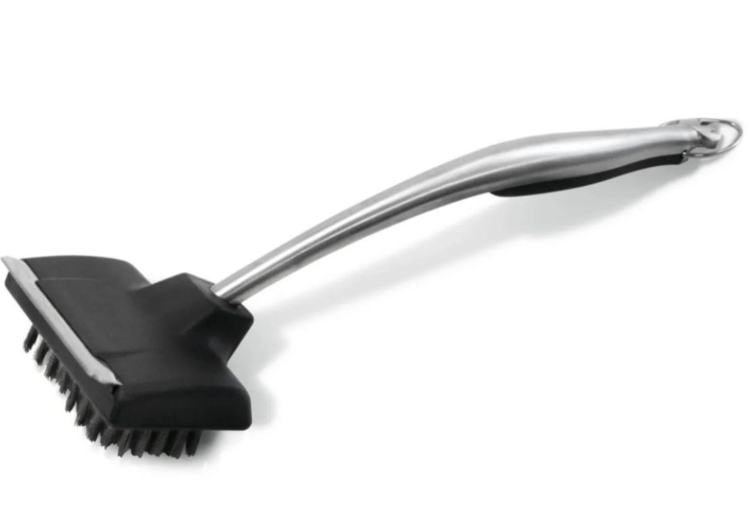 Napoleon PRO Series Stainless Steel Grill Brush: ergonomic handle, stainless steel bristles, metal scraper, and 18-inch length for safe grill cleaning.