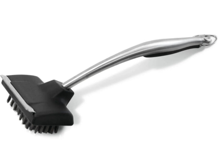 Napoleon PRO Series Stainless Steel Grill Brush: ergonomic handle, stainless steel bristles, metal scraper, and 18-inch length for safe grill cleaning.