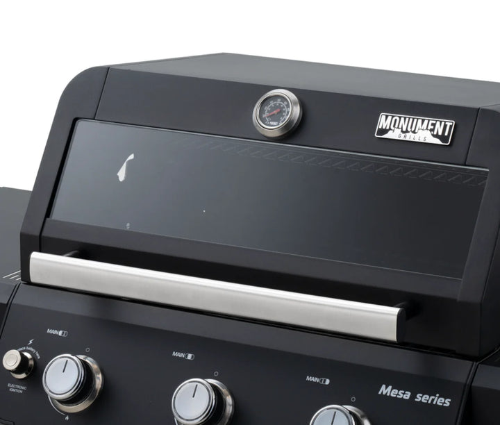 Monument Grills Mesa Series M325 Gas Grill, compact 3-burner propane grill with black powder-coated steel exterior, porcelain-coated cast iron grates, and individual burner knobs for precise temperature control.